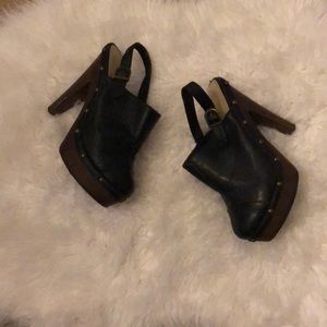 Black faux leather clogs
